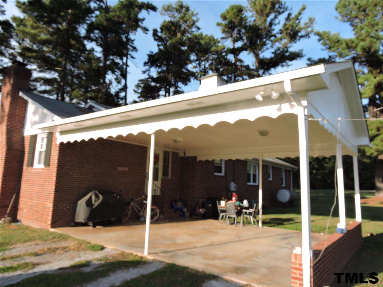 910 Antioch Church Road Timberlake, NC 27583 - Photo 10 of 22 a view of a chair and tables in the patio