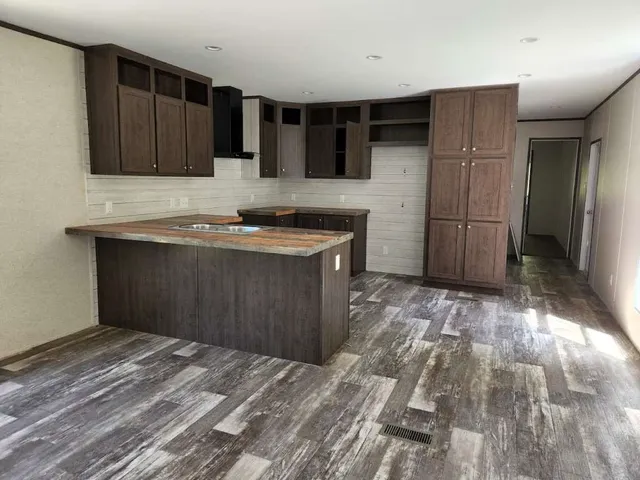 a kitchen with stainless steel appliances granite countertop a sink stove and cabinets