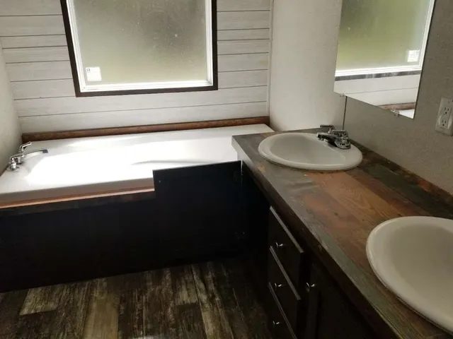 a kitchen with a sink a stove and a mirror