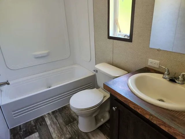 a bathroom with a toilet a sink and bathtub