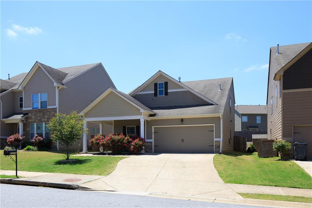 5510 Rialto Way Cumming, GA 30040 - Photo 1 of 1 a front view of a house with a yard and garage