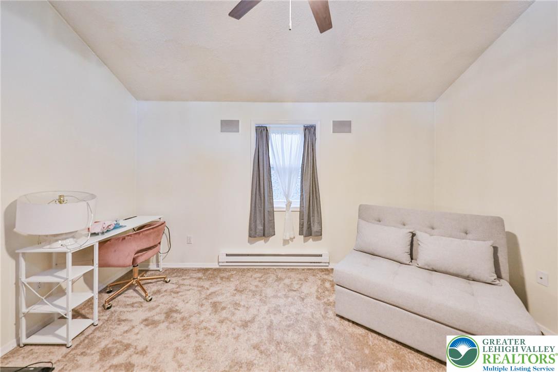 2114 Lakeview Road Bushkill, PA 18324 - Photo 42 of 83 Plush carpeting anchors this versatile living space featuring a centered window and sloped ceilings.