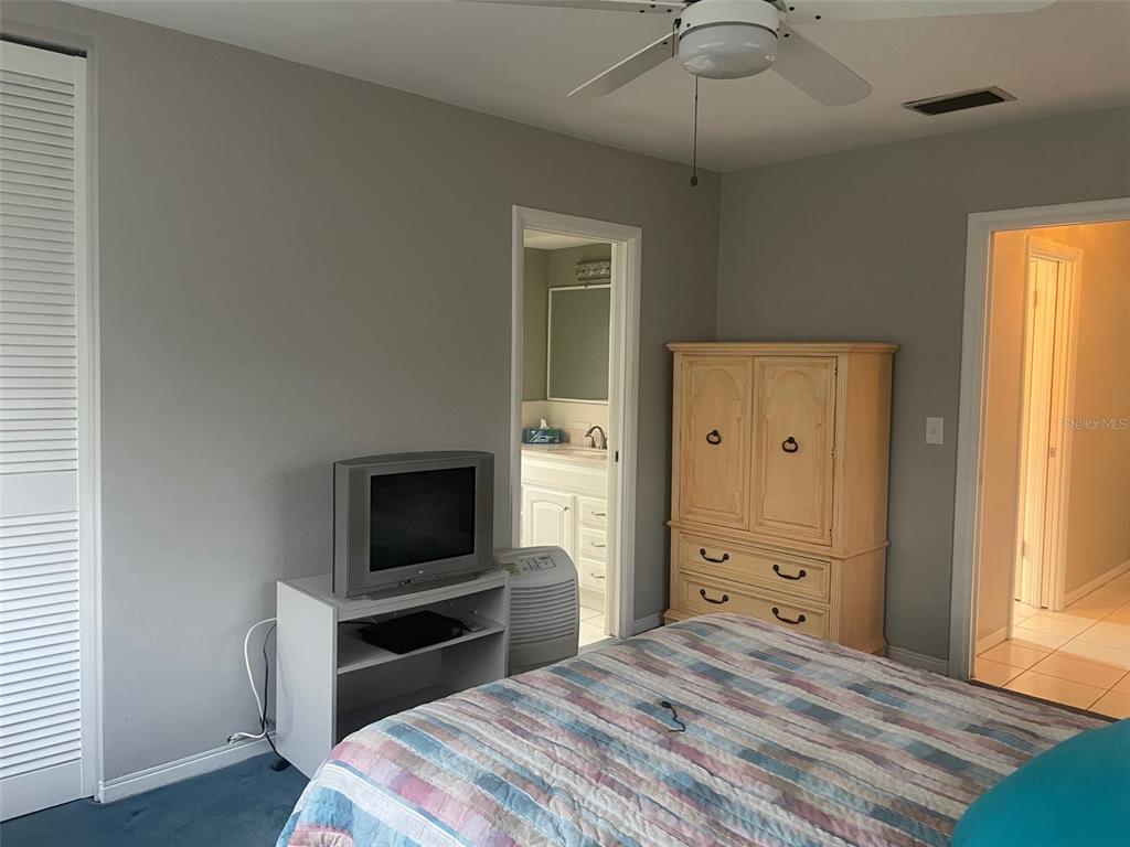 2019 High Ridge Drive Clearwater, FL 33763 - Photo 16 of 30 a bedroom with a bed and a flat screen tv