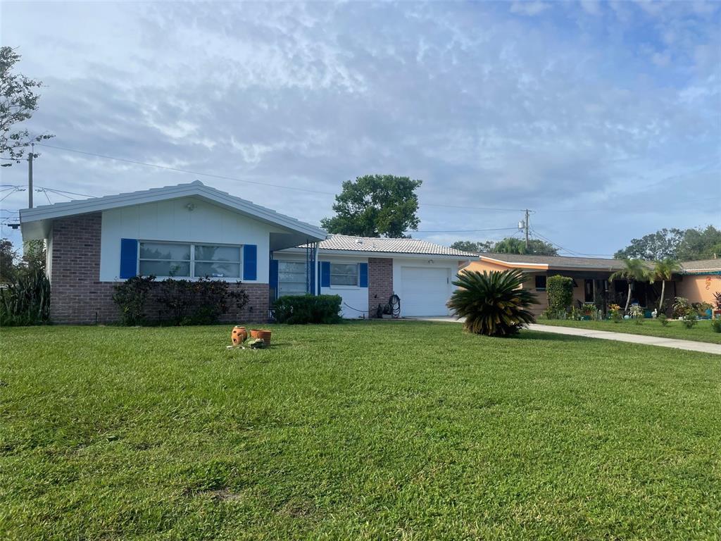 2019 High Ridge Drive Clearwater, FL 33763 - Photo 24 of 30 a front view of a house with garden