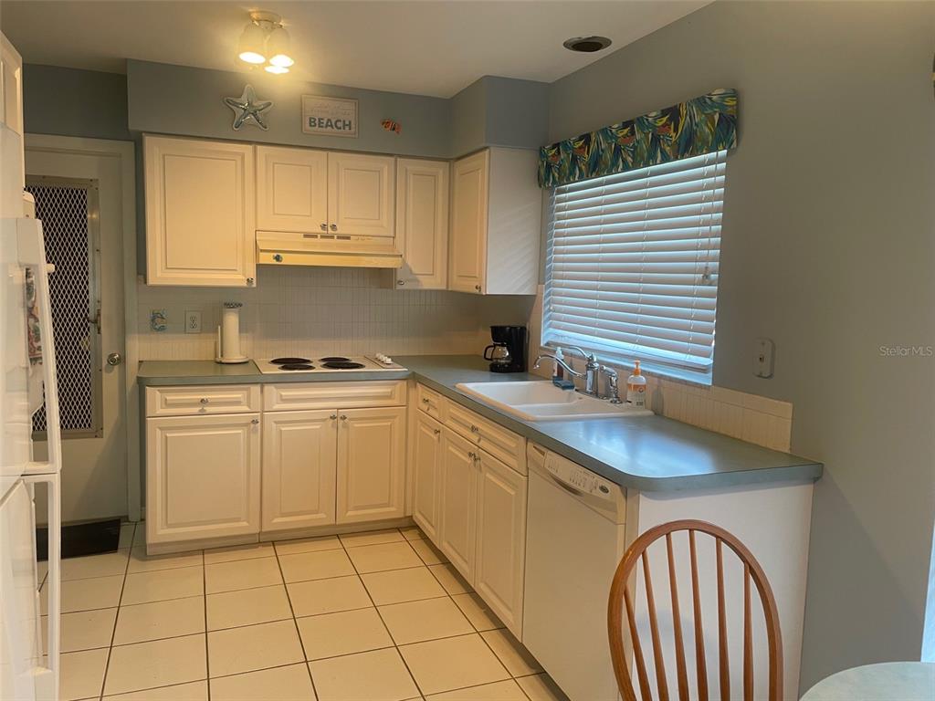 2019 High Ridge Drive Clearwater, FL 33763 - Photo 7 of 30 a kitchen with a sink cabinets and appliances
