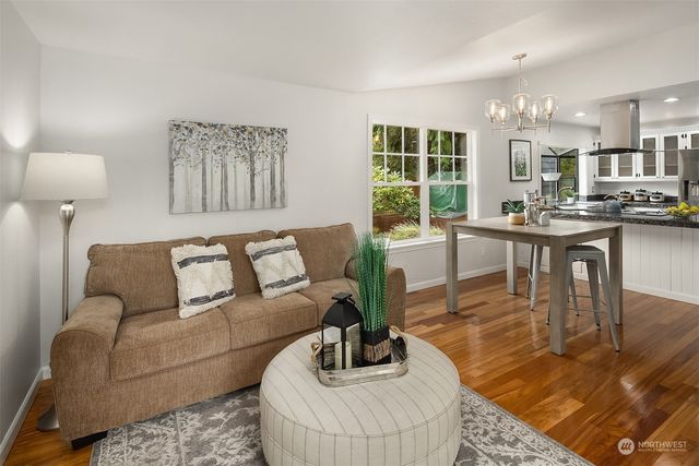 a view of a dining room with furniture and chandelier