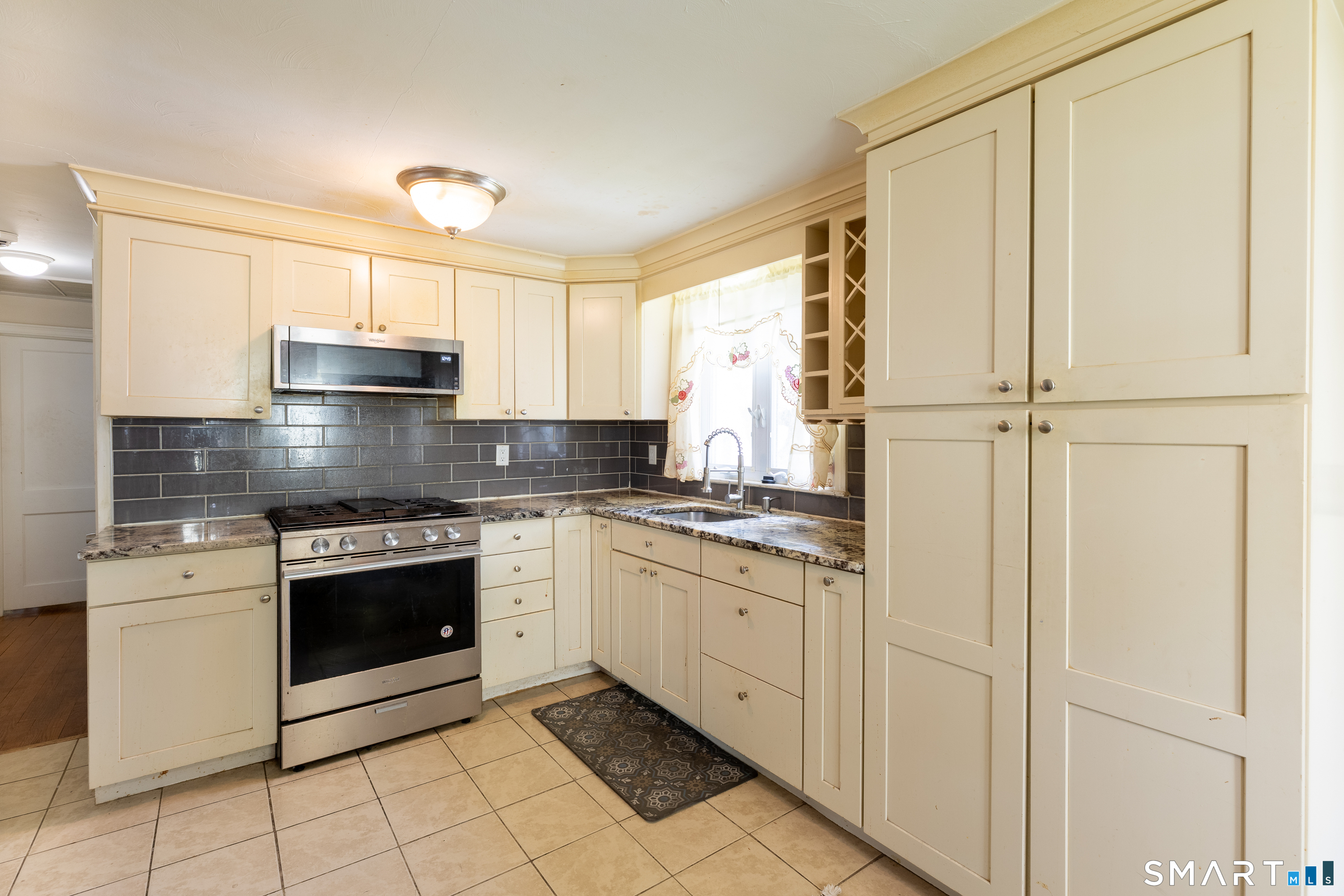 170 Amherst Street Hartford, CT 06106 - Photo 12 of 24 a kitchen with stainless steel appliances granite countertop a stove a sink and a refrigerator