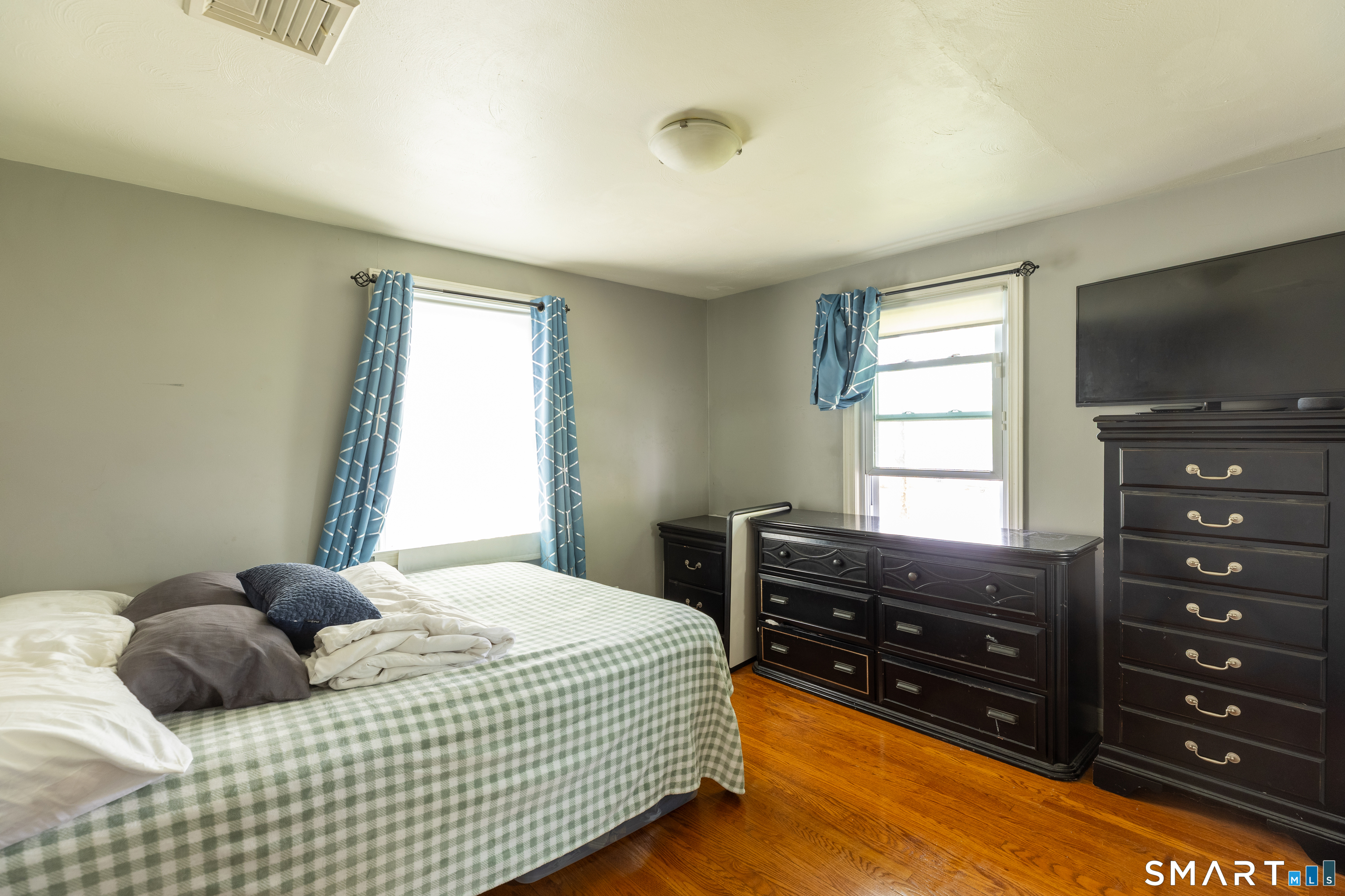 170 Amherst Street Hartford, CT 06106 - Photo 14 of 24 a bedroom with a bed and a flat tv screen on dresser