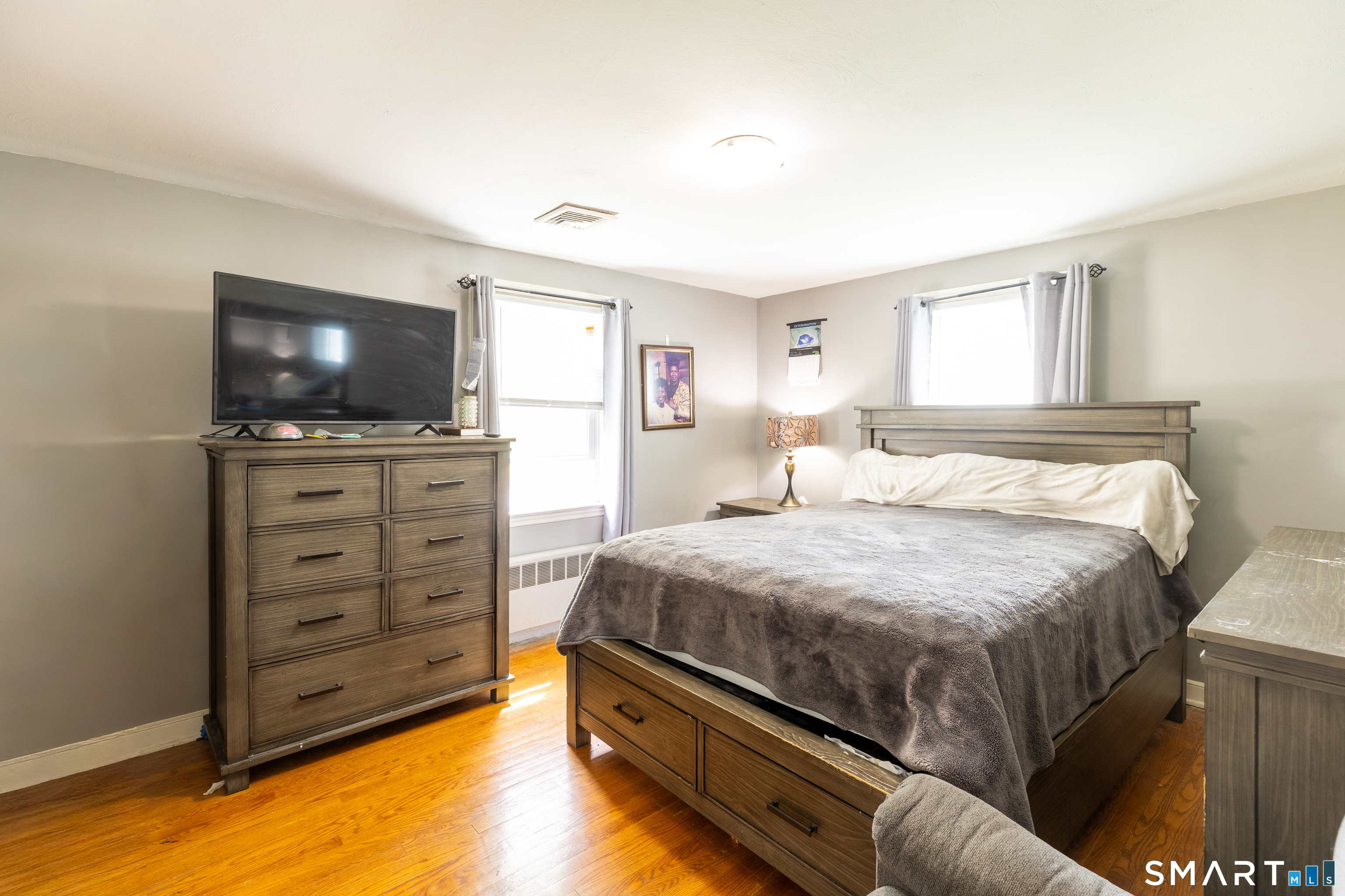 170 Amherst Street Hartford, CT 06106 - Photo 15 of 24 a bedroom with a bed and a flat screen tv
