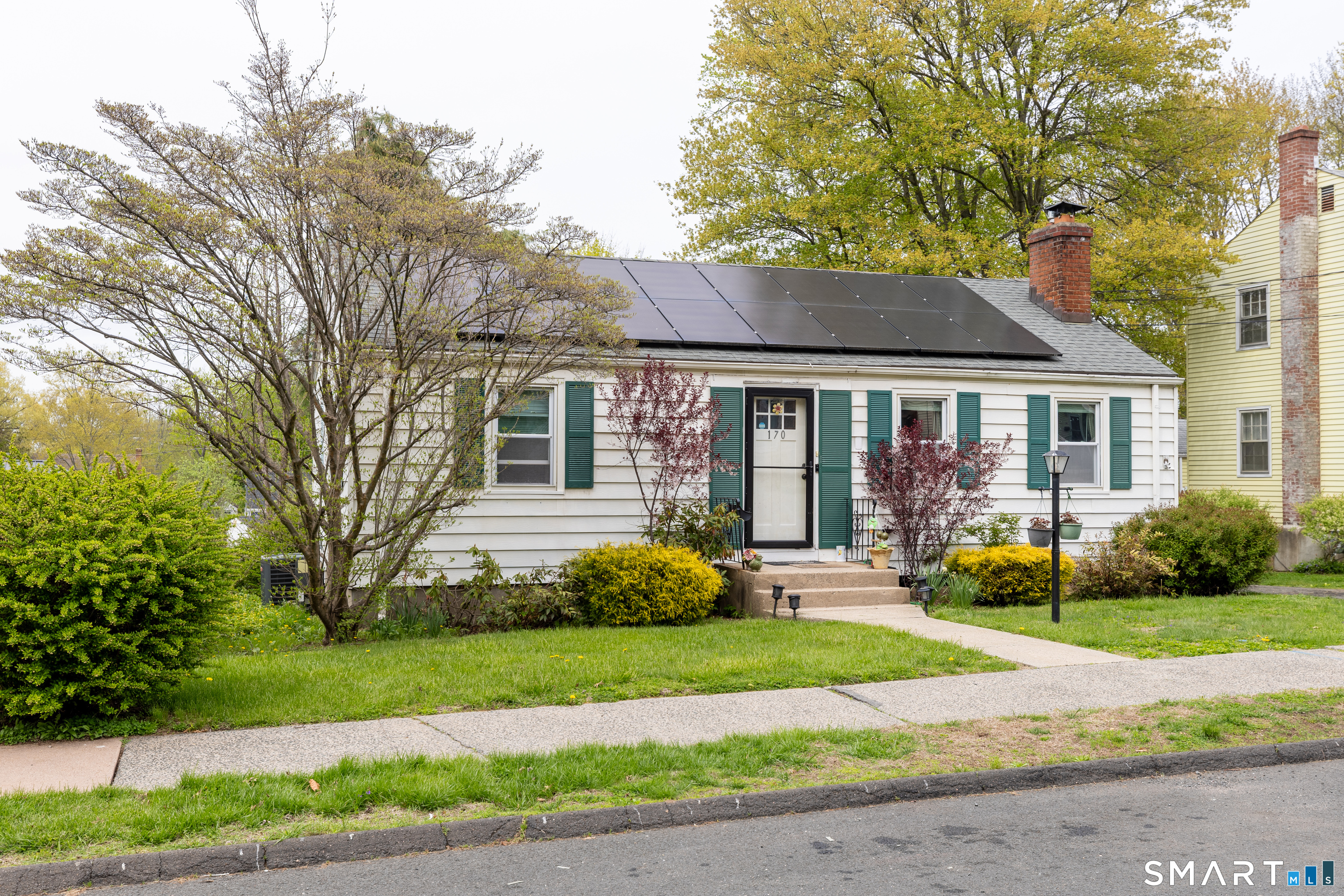 170 Amherst Street Hartford, CT 06106 - Photo 2 of 24 a front view of a house with a garden and trees