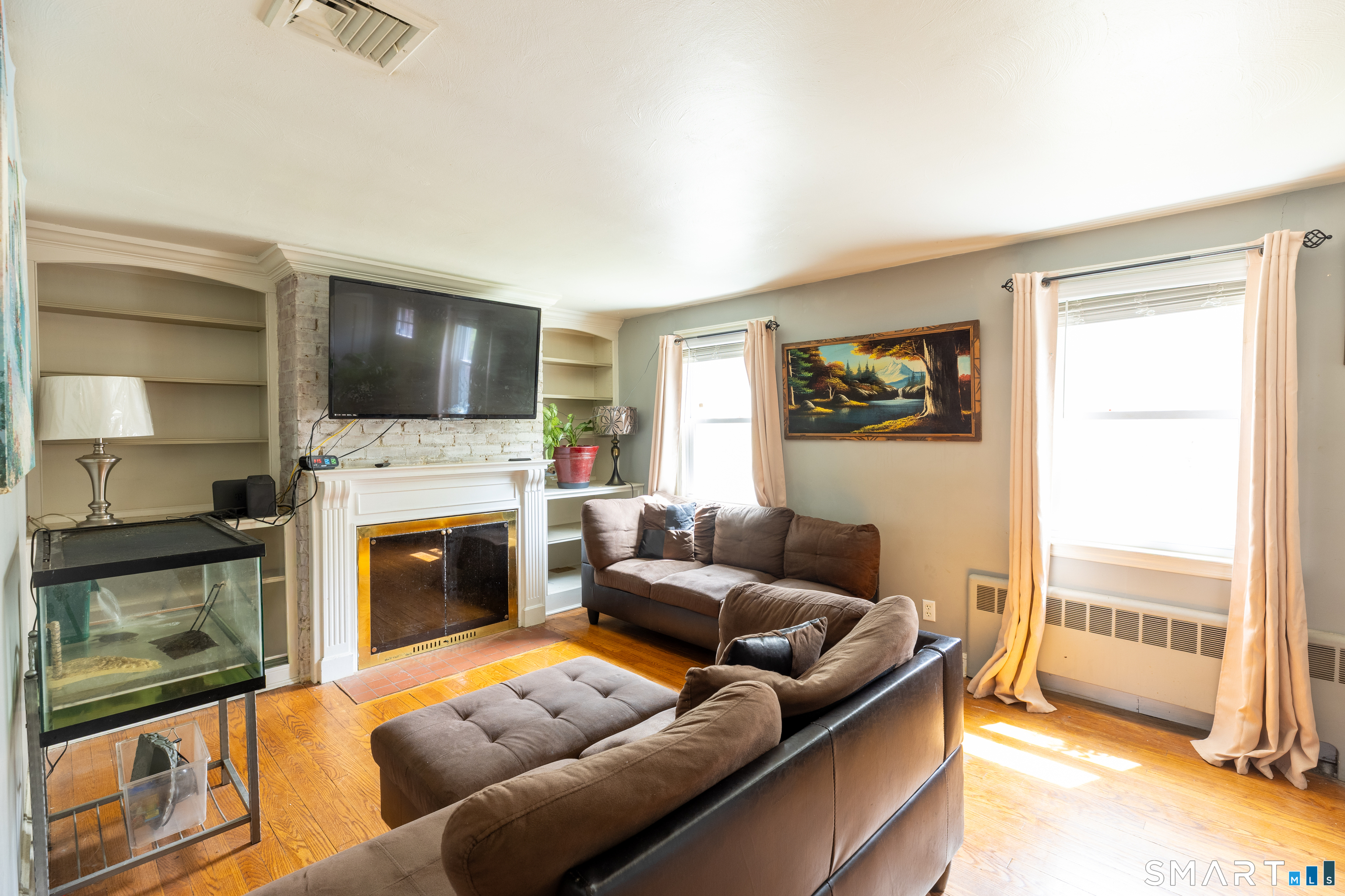 170 Amherst Street Hartford, CT 06106 - Photo 7 of 24 a living room with furniture a flat screen tv and a fireplace