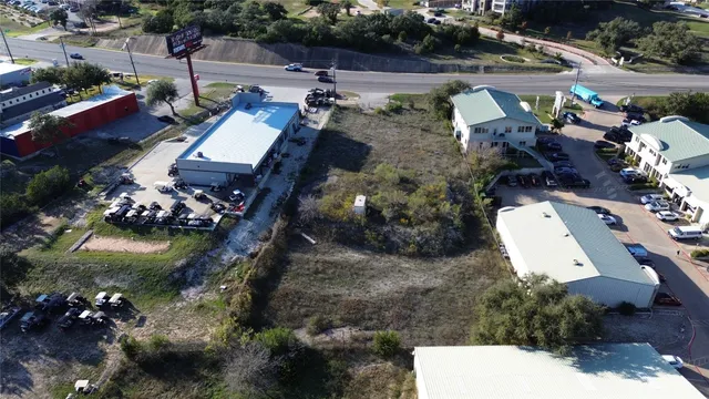 an aerial view of multiple houses with yard
