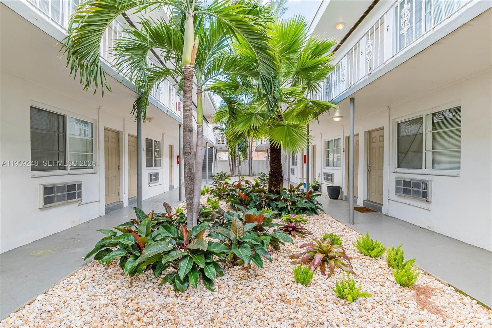 6921 Rue Vendome, Unit 10 Miami Beach, FL 33141 - Photo 20 of 27 a front view of a house with a flower garden