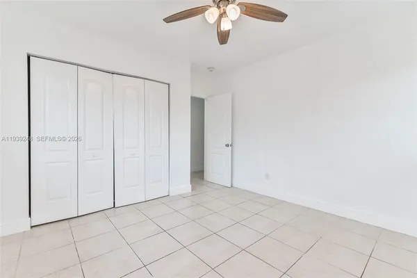 an empty room with chandelier fan
