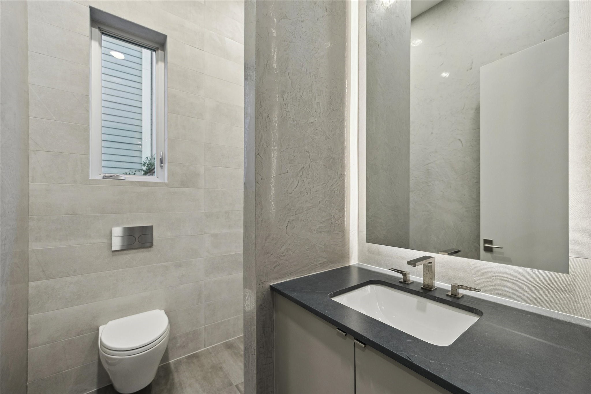 2129 Quenby Street Houston, TX 77005 - Photo 11 of 37 a bathroom with a granite countertop sink toilet and mirror
