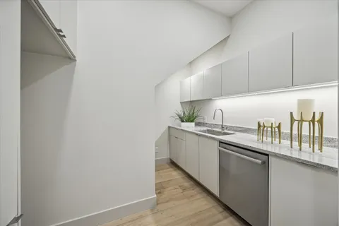 a kitchen with granite countertop a sink and cabinets