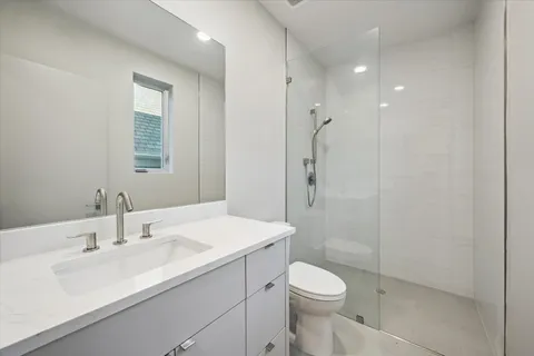 a bathroom with a sink toilet and shower