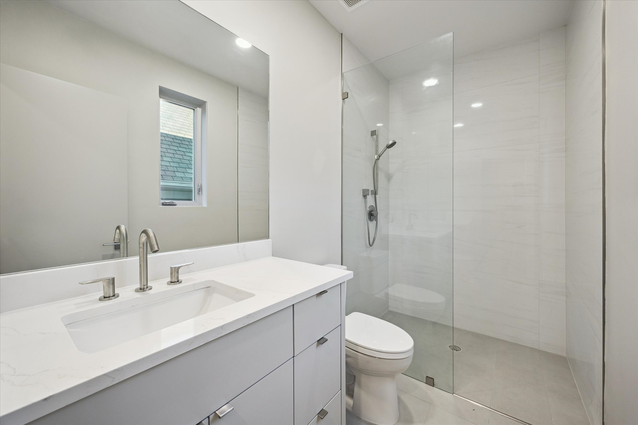 2129 Quenby Street Houston, TX 77005 - Photo 15 of 37 a bathroom with a sink toilet and shower