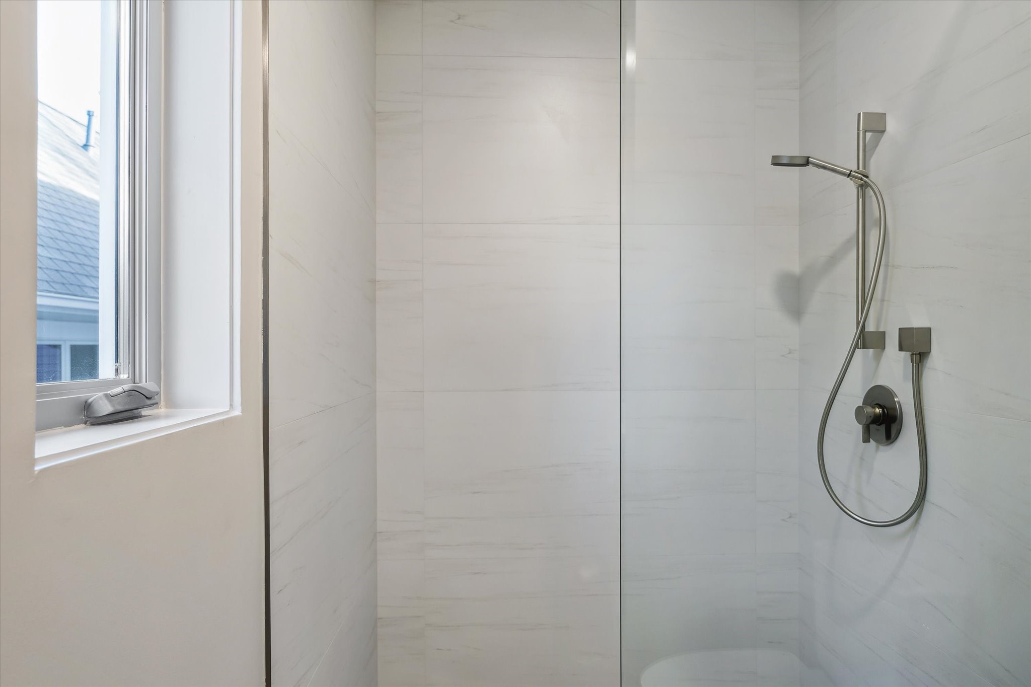 2129 Quenby Street Houston, TX 77005 - Photo 19 of 37 a bathroom with a glass shower door