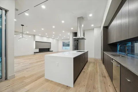 a large kitchen with stainless steel appliances kitchen island a large counter top and a stove top oven