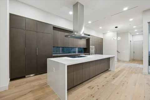 a large kitchen with a stove a sink and a refrigerator