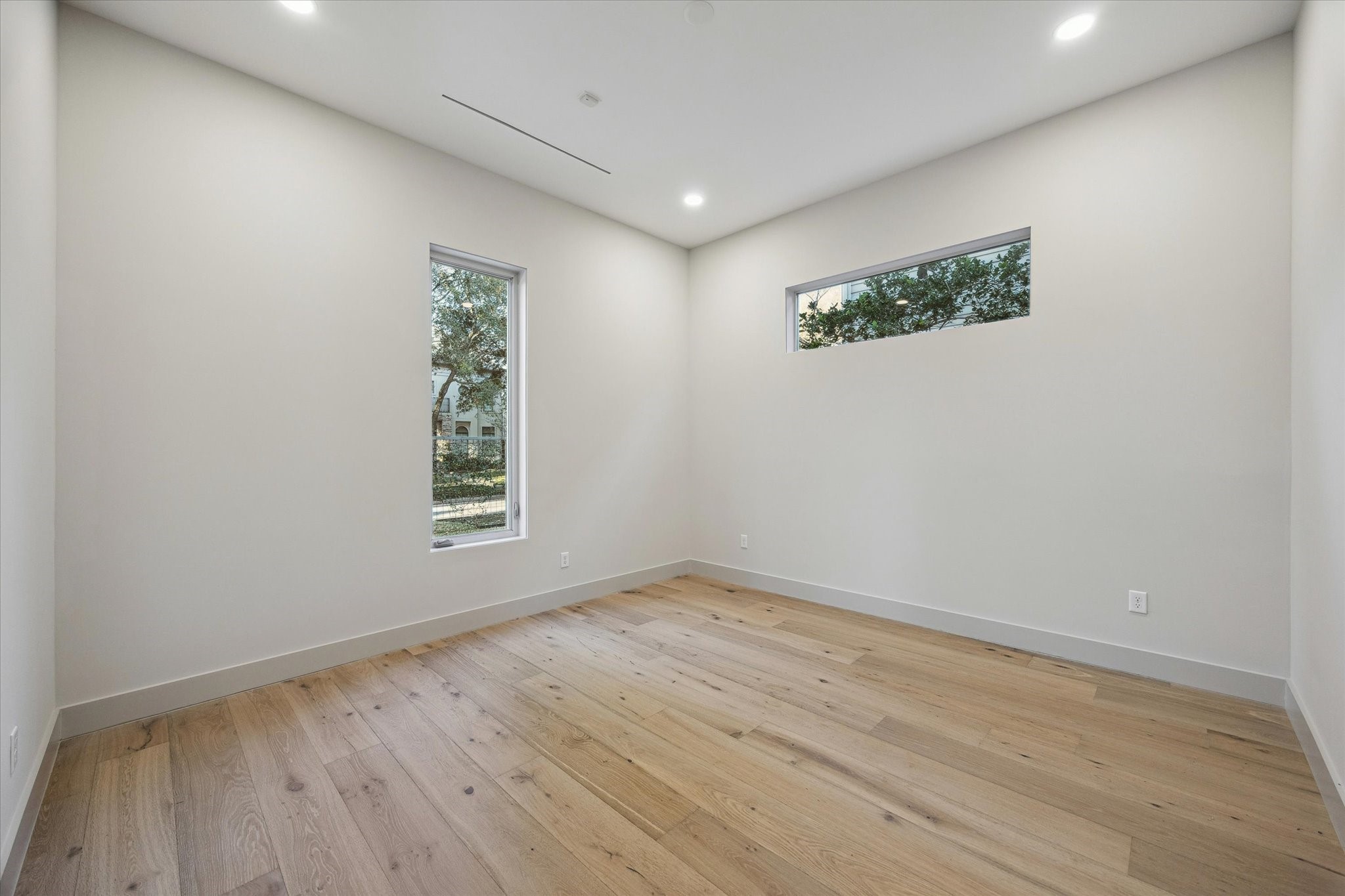 2129 Quenby Street Houston, TX 77005 - Photo 10 of 37 an empty room with wooden floor and window