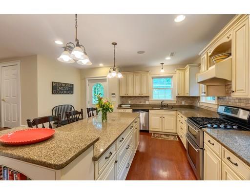 31 Boston Road Chelmsford, MA 01824 - Photo 15 of 42 a kitchen with stainless steel appliances granite countertop a stove a sink a refrigerator white cabinets and couches with wooden floor