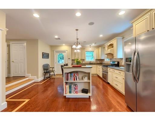 31 Boston Road Chelmsford, MA 01824 - Photo 18 of 42 a kitchen with stainless steel appliances granite countertop a refrigerator a sink dishwasher a dining table and chairs with wooden floor