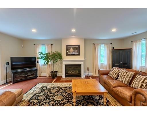 31 Boston Road Chelmsford, MA 01824 - Photo 21 of 42 a living room with furniture a flat screen tv and a fireplace