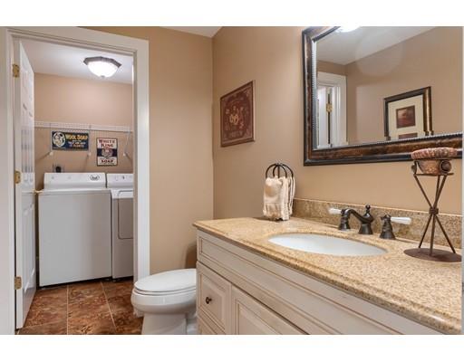 31 Boston Road Chelmsford, MA 01824 - Photo 25 of 42 a bathroom with a granite countertop sink a toilet and a mirror
