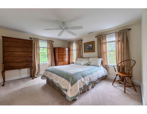 31 Boston Road Chelmsford, MA 01824 - Photo 28 of 42 a spacious bedroom with a bed a chair and a large window