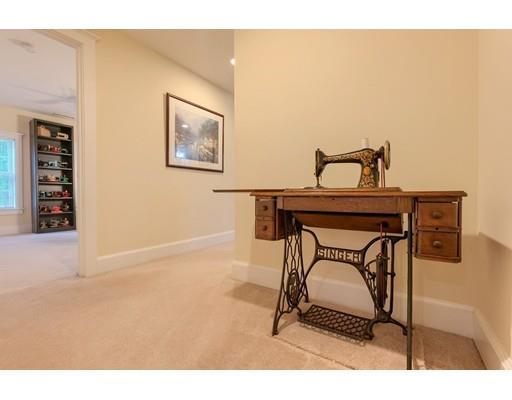 31 Boston Road Chelmsford, MA 01824 - Photo 32 of 42 a living room with a chair a table and a painting