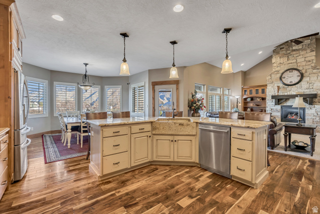 896 West 675 South Mapleton, UT 84664 - Photo 8 of 77 Kitchen featuring pendant lighting, cream cabinets, light stone counters, appliances with stainless steel finishes, and a textured ceiling