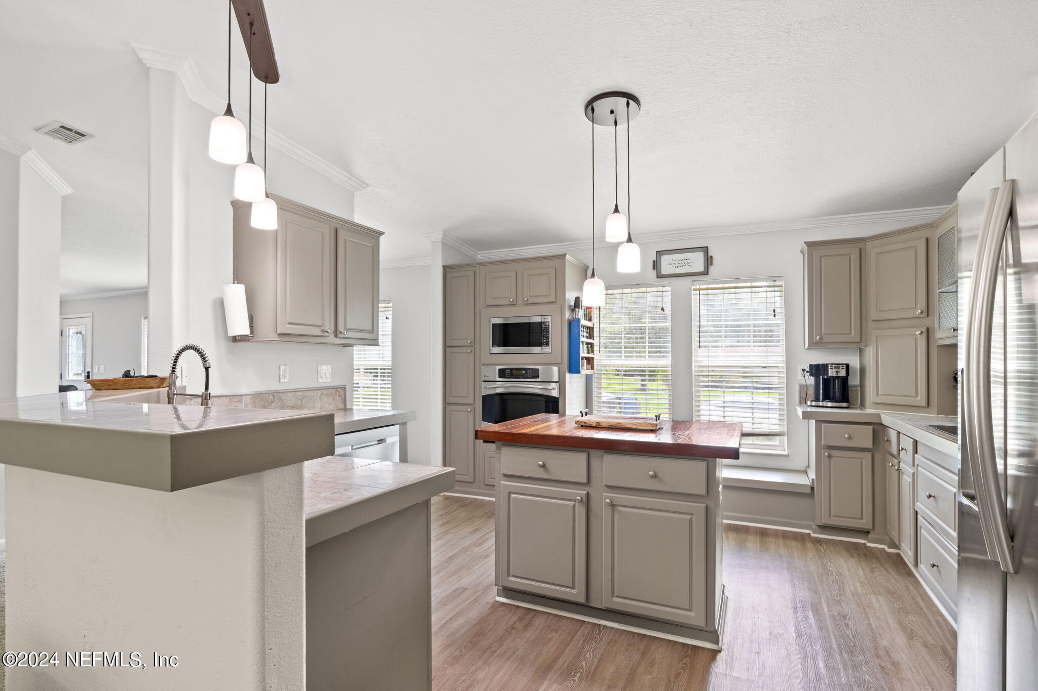 54037 Parks Road Callahan, FL 32011 - Photo 11 of 26 a kitchen with white cabinets and appliances