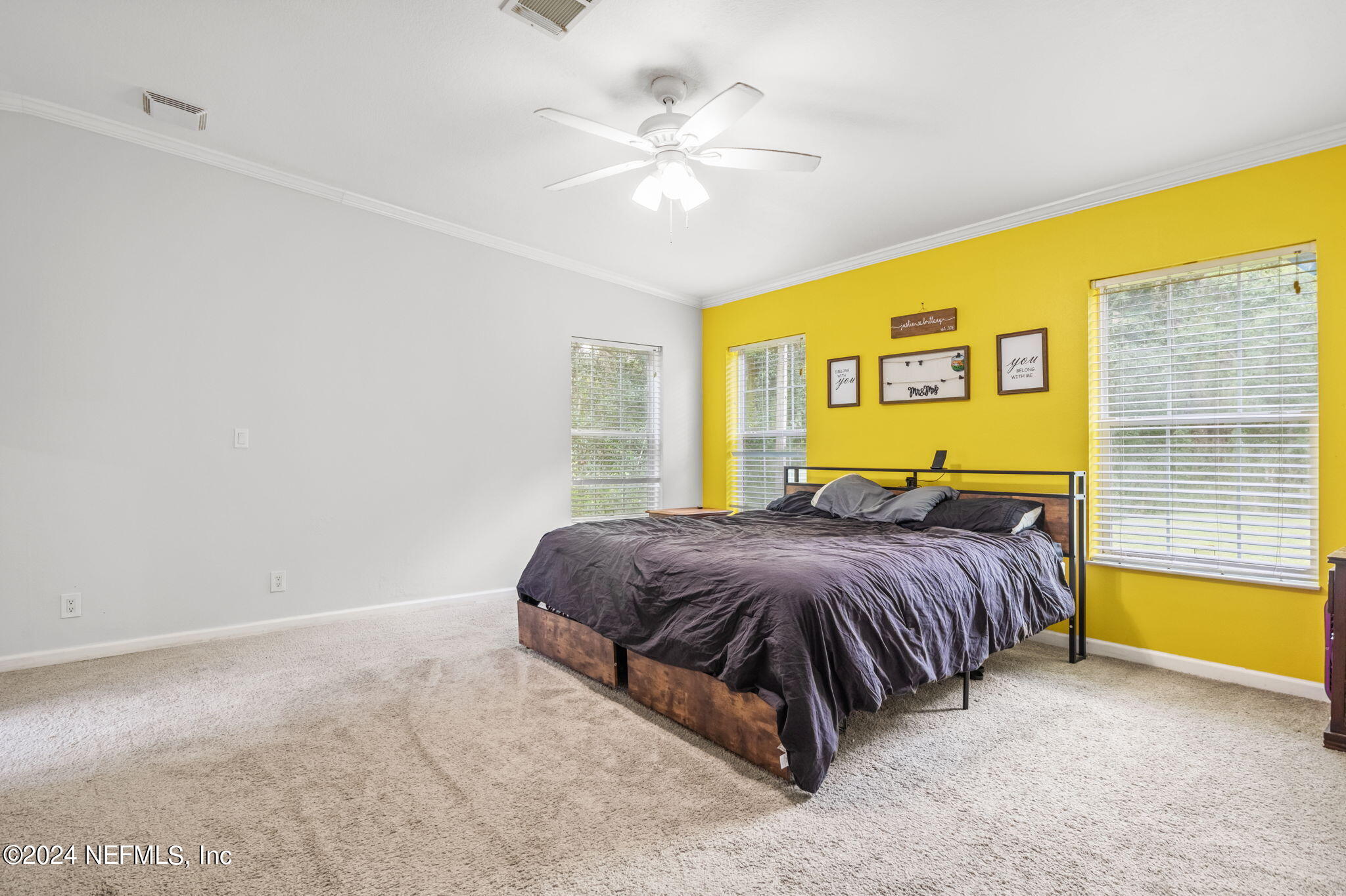 54037 Parks Road Callahan, FL 32011 - Photo 13 of 26 a bedroom with a bed and a chandelier
