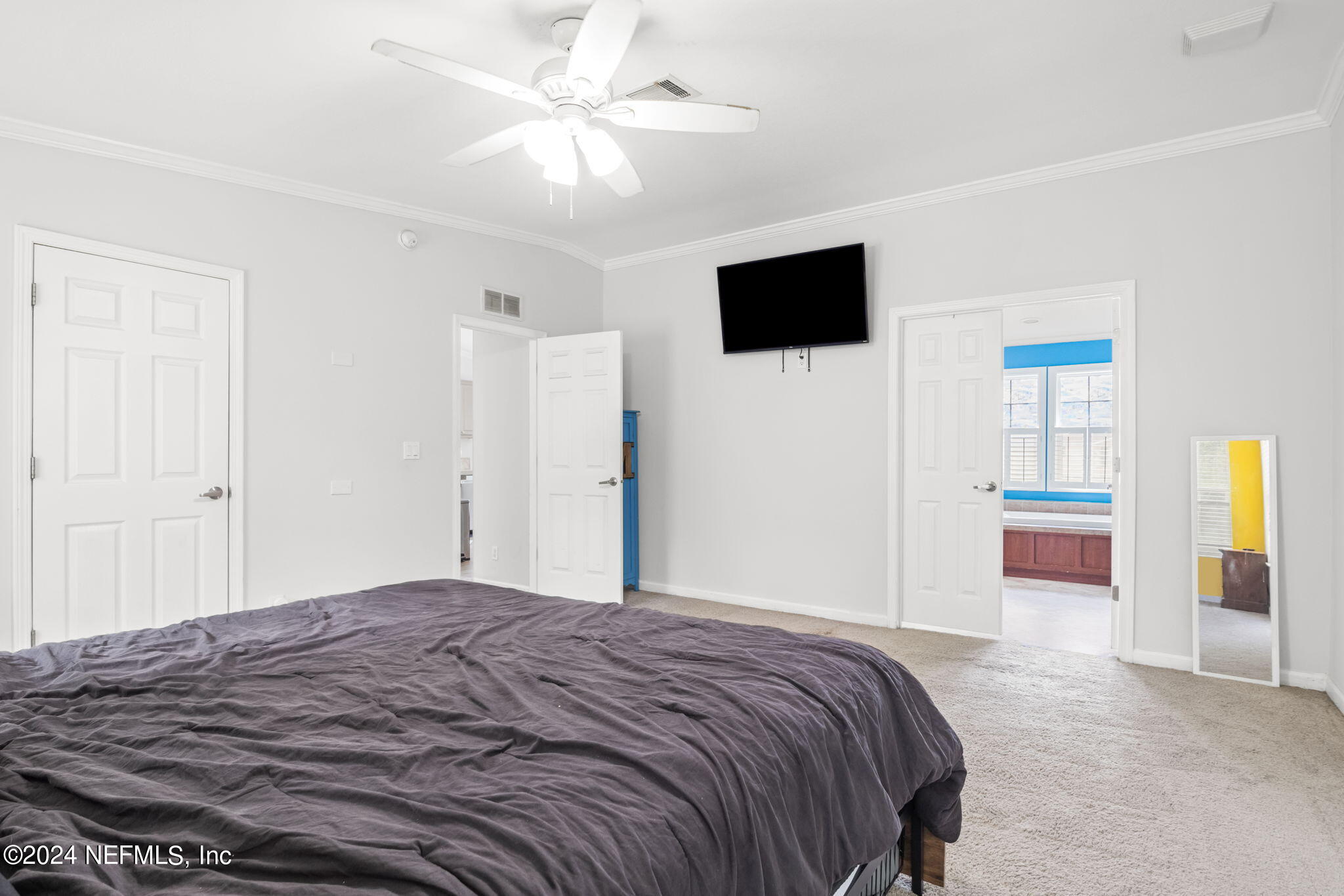 54037 Parks Road Callahan, FL 32011 - Photo 14 of 26 a bedroom with a large bed a flat tv screen and dresser