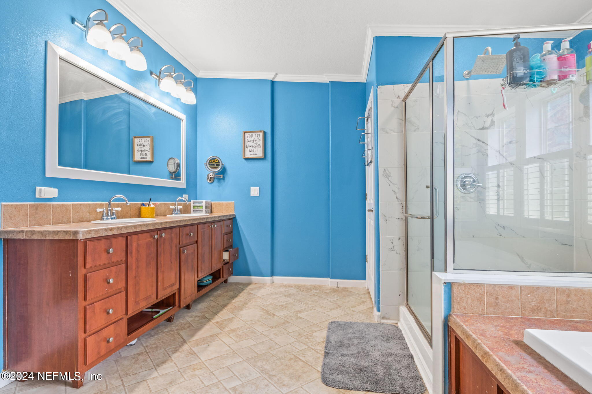 54037 Parks Road Callahan, FL 32011 - Photo 15 of 26 a bathroom with a sink a mirror and a shower