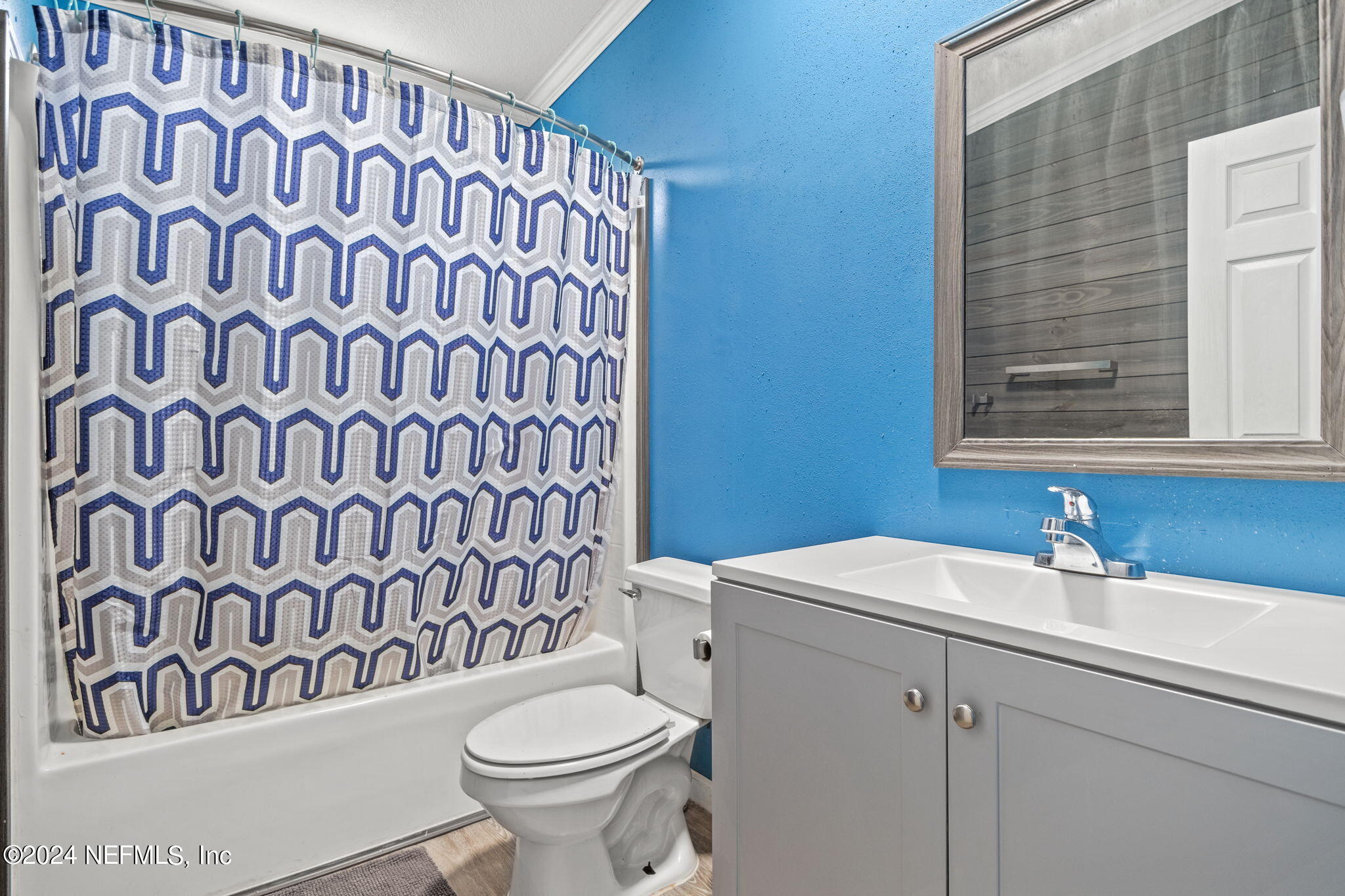 54037 Parks Road Callahan, FL 32011 - Photo 17 of 26 a bathroom with a sink and mirror with toilet
