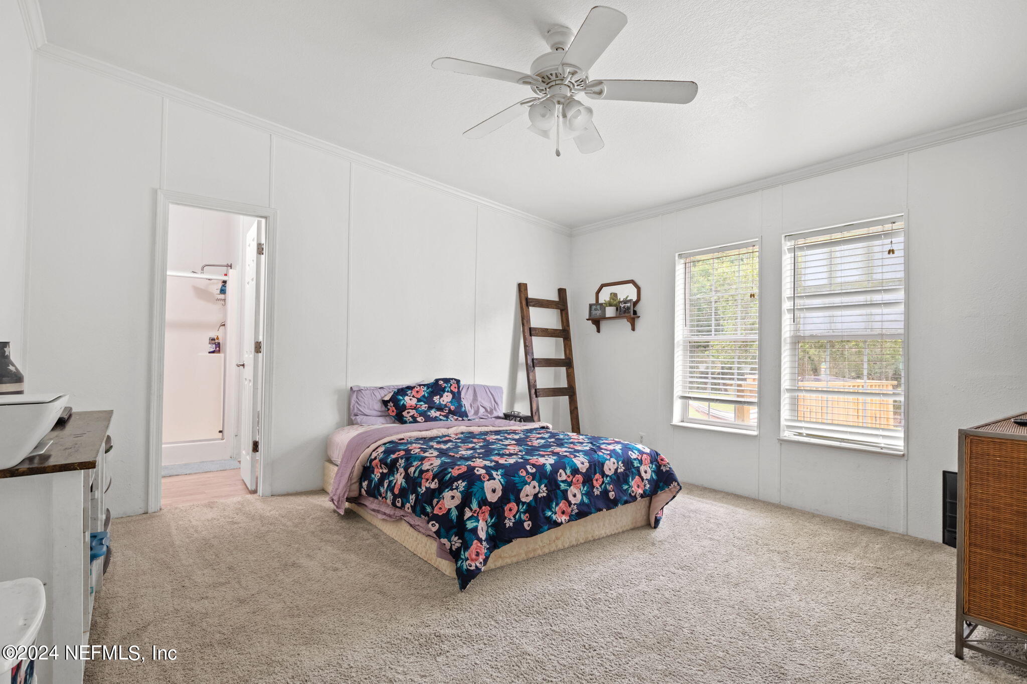 54037 Parks Road Callahan, FL 32011 - Photo 18 of 26 a bedroom with a bed and a chandelier