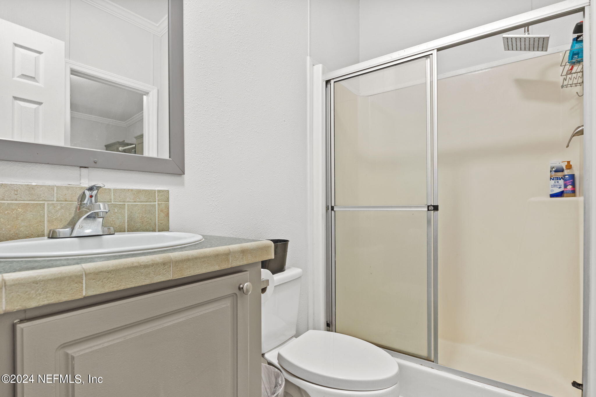 54037 Parks Road Callahan, FL 32011 - Photo 21 of 26 a bathroom with a sink a toilet and shower