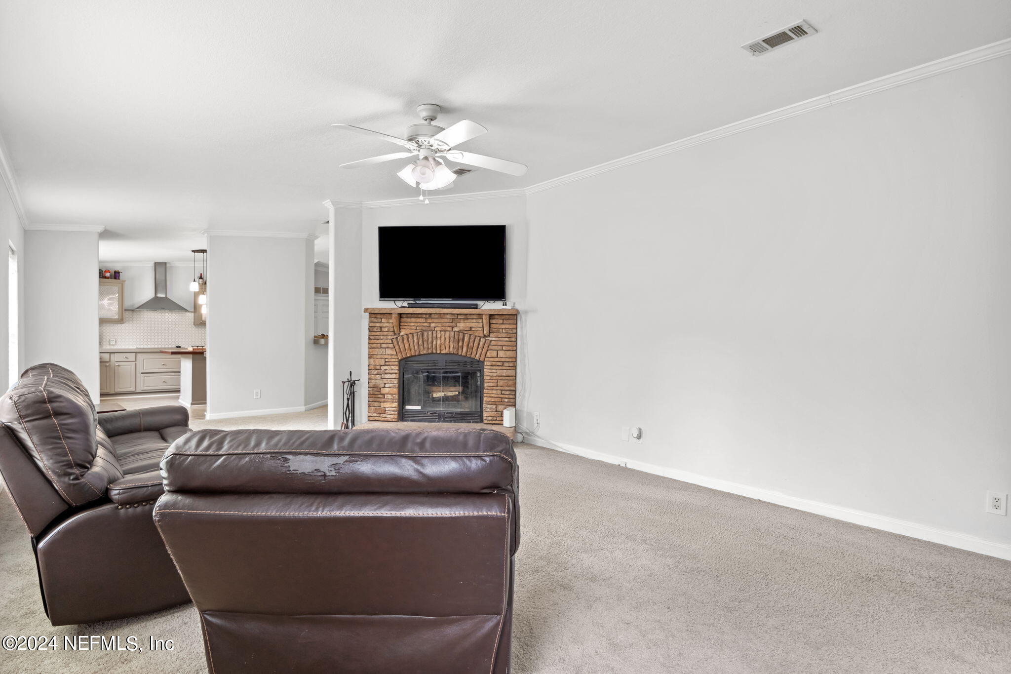 54037 Parks Road Callahan, FL 32011 - Photo 5 of 26 a living room with furniture a fireplace and a flat screen tv
