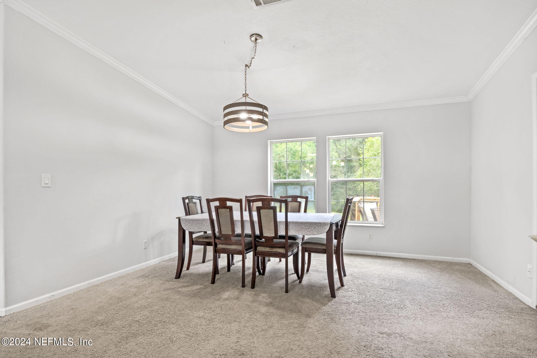 54037 Parks Road Callahan, FL 32011 - Photo 6 of 26 a dining room with furniture a chandelier and window