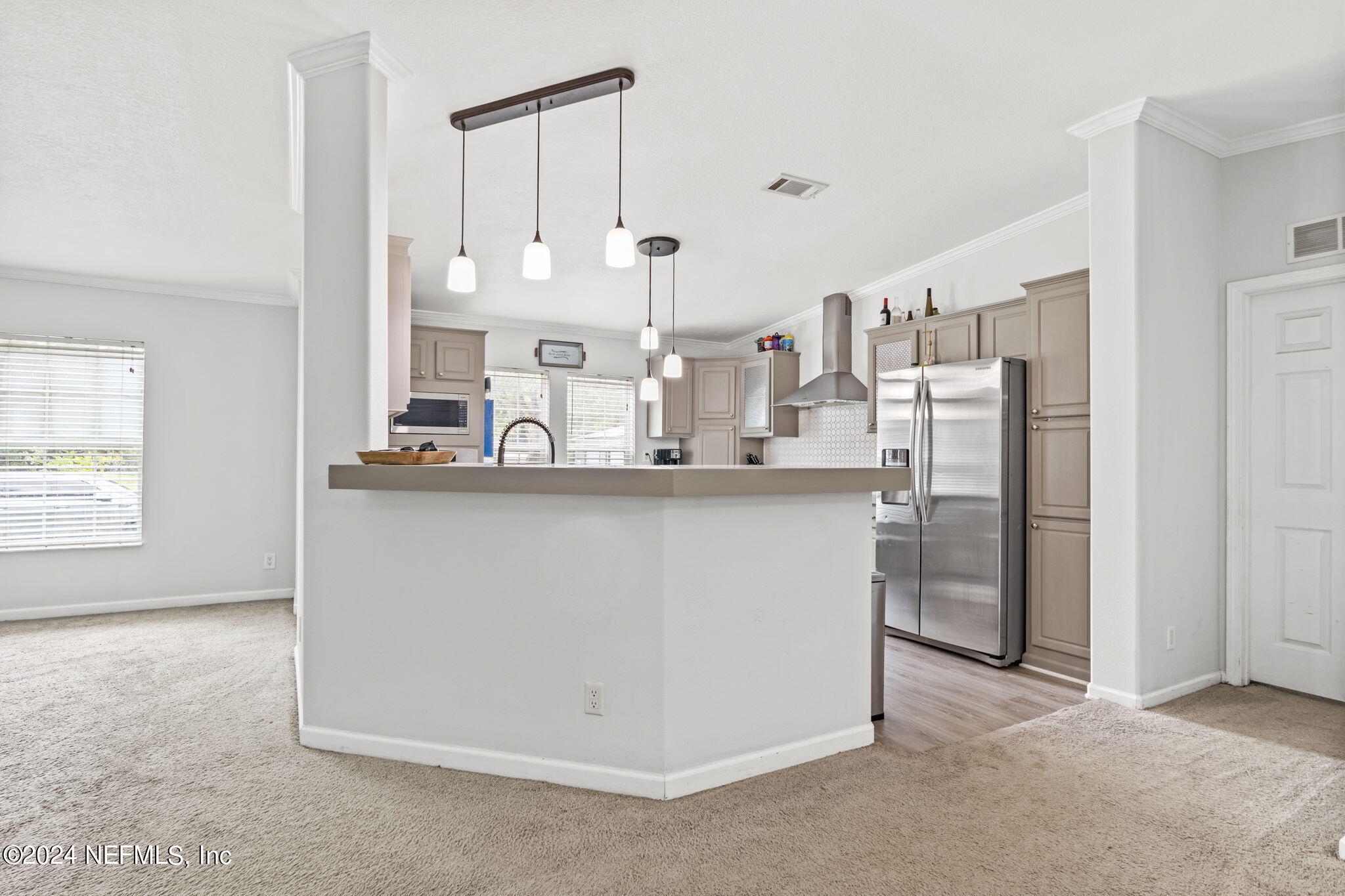 54037 Parks Road Callahan, FL 32011 - Photo 8 of 26 a kitchen with stainless steel appliances a refrigerator and white cabinets
