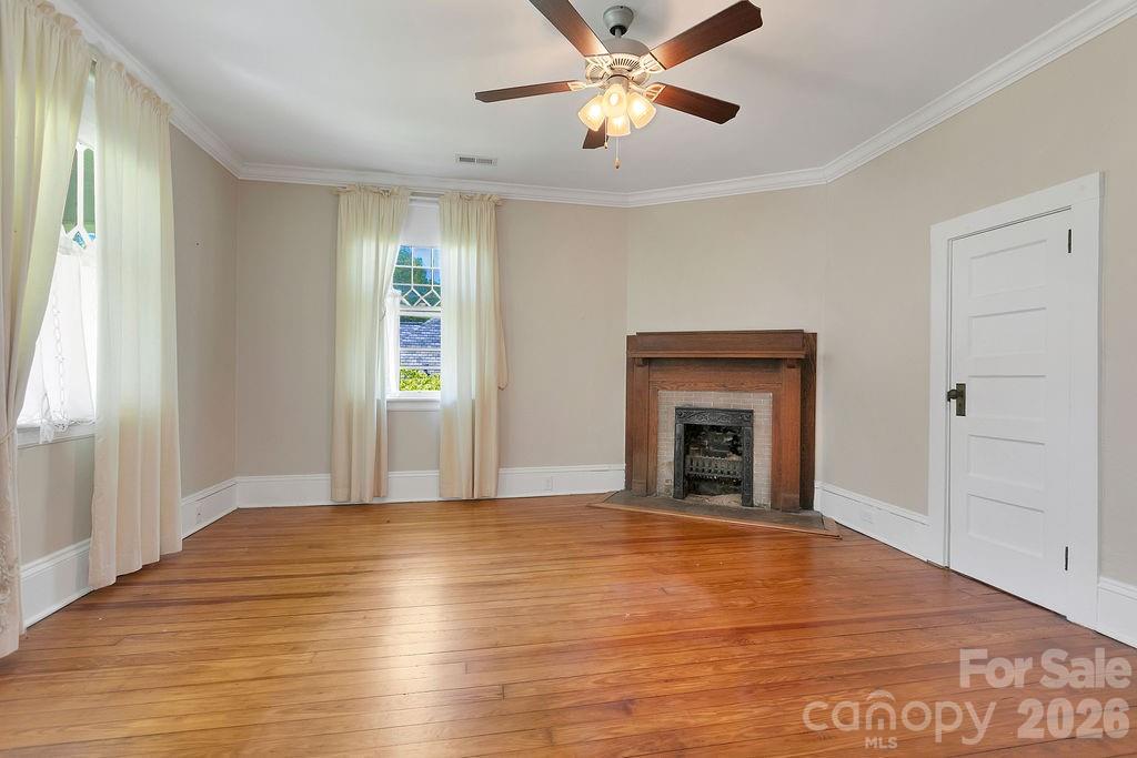 208 West Probart Street Brevard, NC 28712 - Photo 40 of 48 a view of an empty room with window and wooden floor