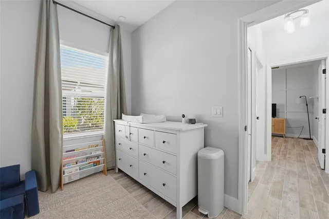 a bedroom with a bed and a flat tv screen on dresser