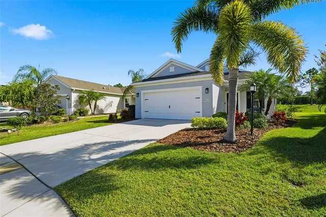 a front view of a house with a yard and garage