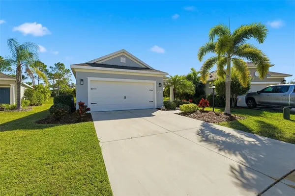 a front view of a house with a yard and garage