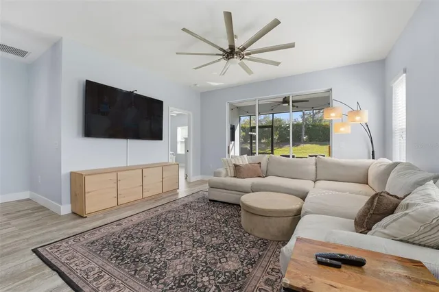 a living room with furniture and kitchen view