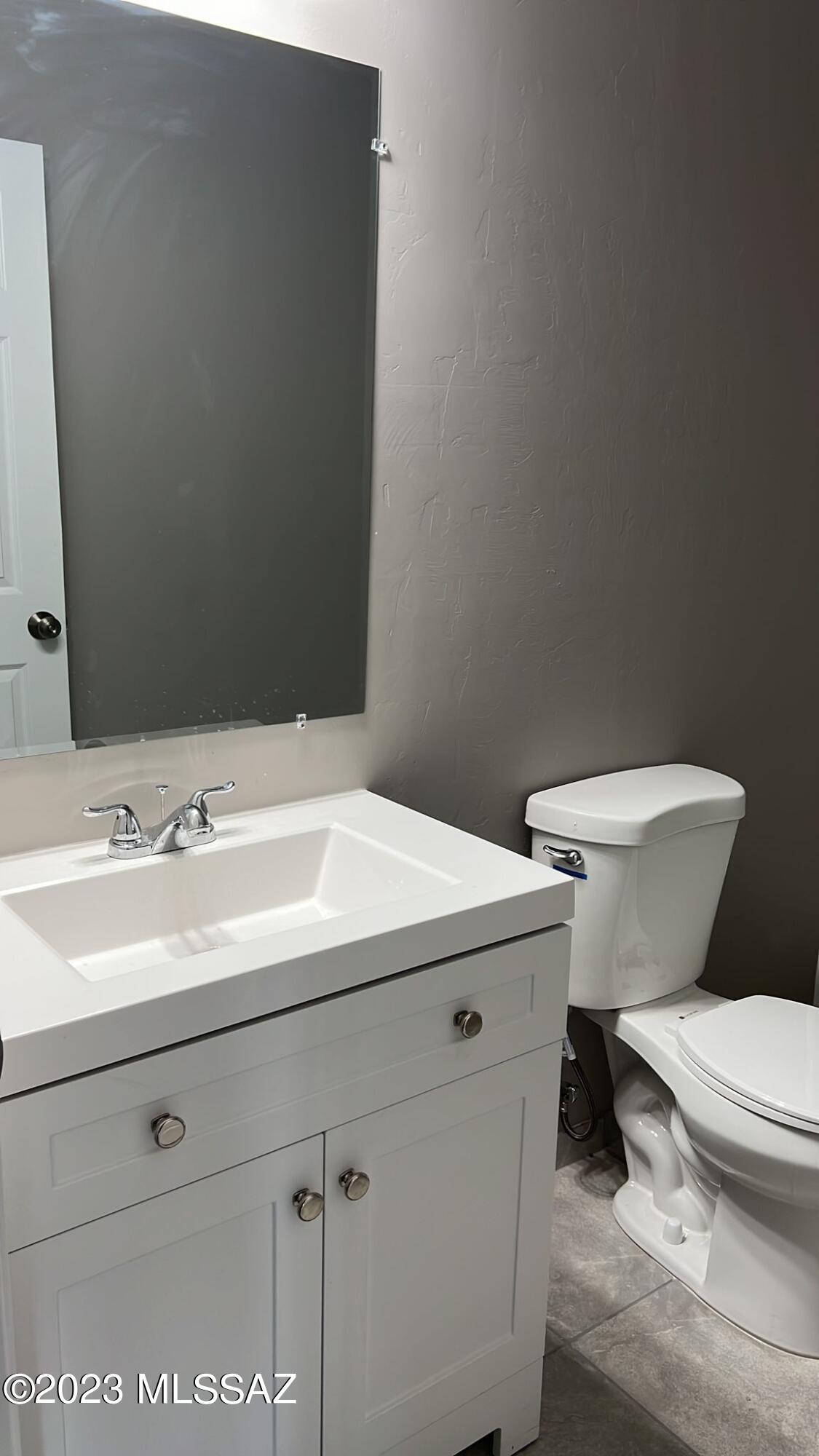 8957 West Bopp Road Tucson, AZ 85735 - Photo 6 of 14 a white toilet sitting next to a bathroom sink