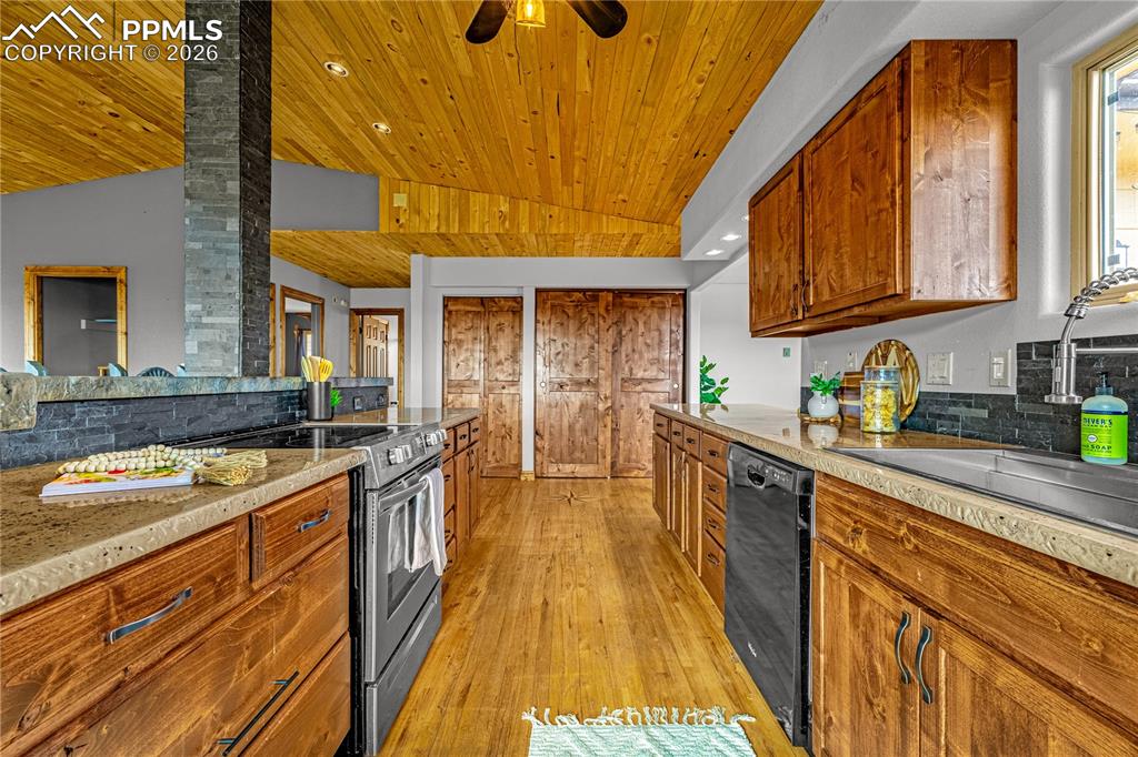 845 Crystal Park Road Manitou Springs, CO 80829 - Photo 11 of 50 a kitchen with stainless steel appliances granite countertop a stove and a sink